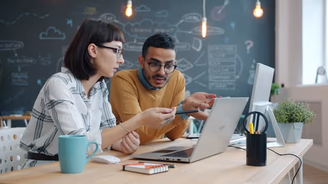 Person working on a laptop in a modern workspace